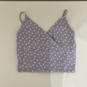 This cropped tank top is purple in size small and the brand is hollister.